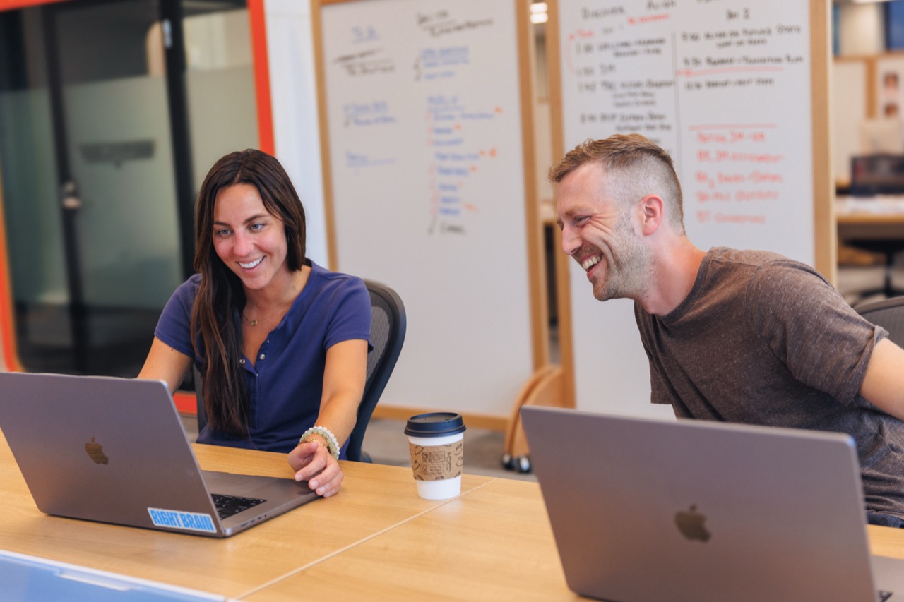 Caldera team collaborating at a table with laptops